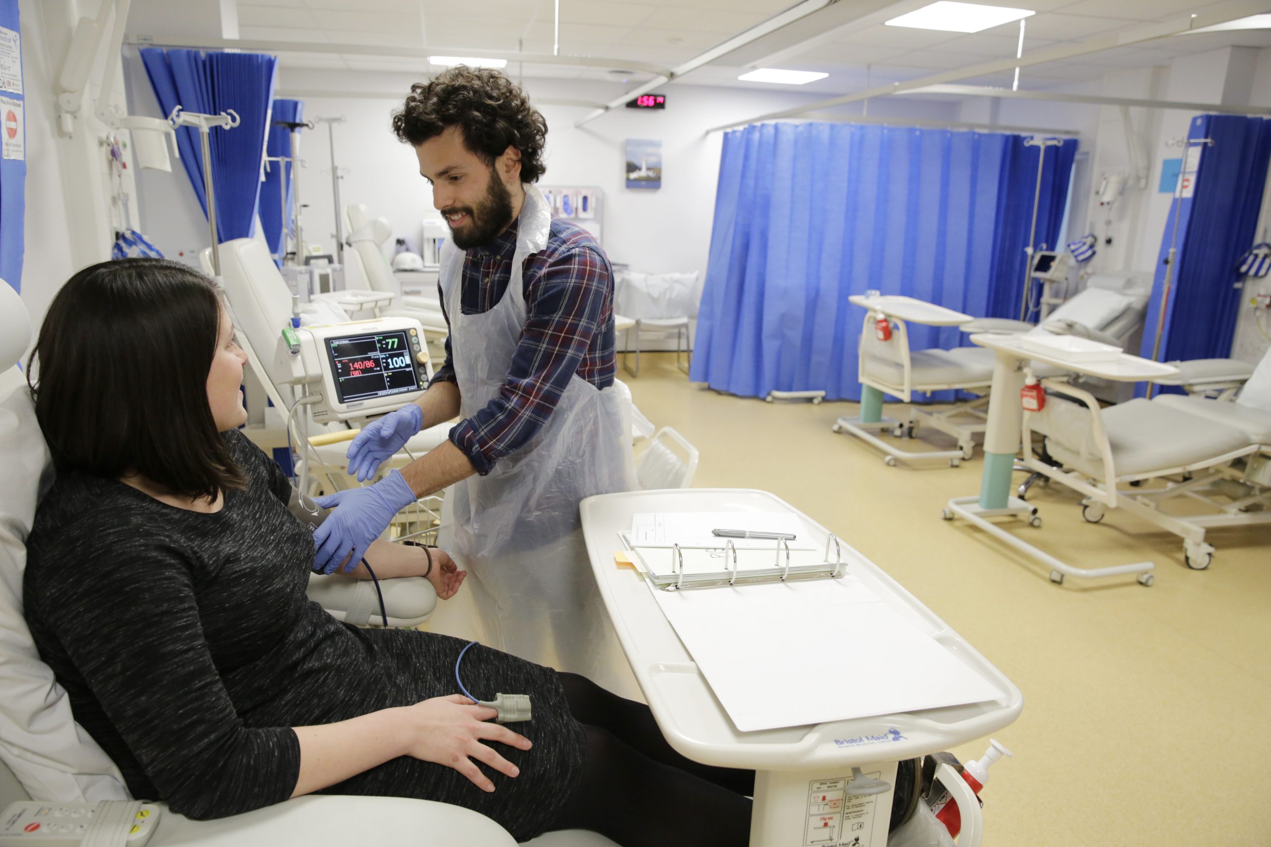 Nurse with patient in the trials procedure room at the Experimental Medicine Facility